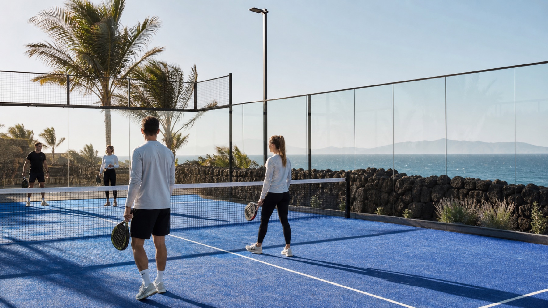 Winterlicher Padel-Court auf einer warmen Insel mit Vulkanstein, Palmen und Atlantikblick